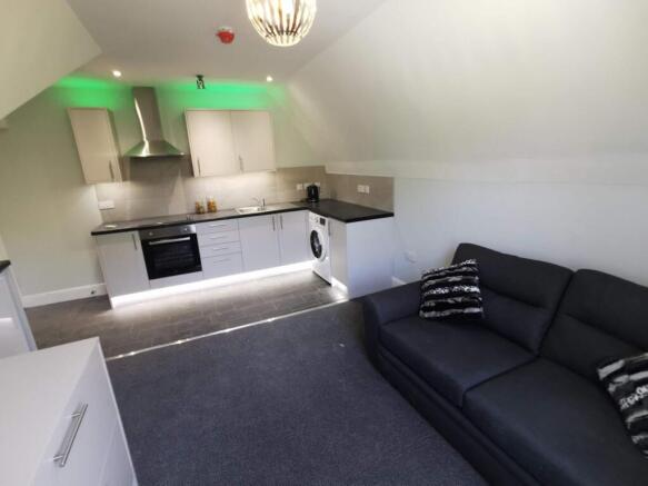 Modern open-plan living area with vibrant LED l...