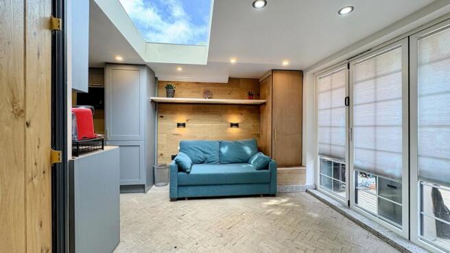 Bright modern lounge with skylight and sofa...