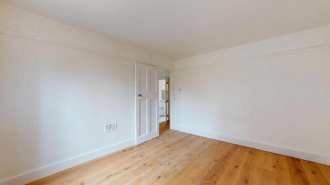 A spacious, well-maintained master bedroom feat...