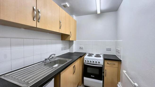 Clean kitchen with ample storage space...