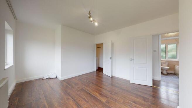 Spacious master bedroom with modern flooring...