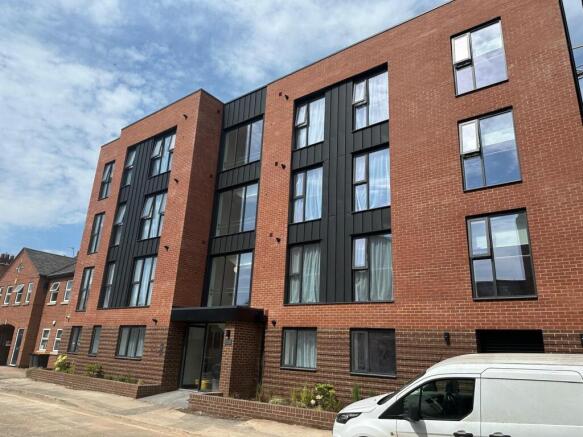 Modern brick apartment building with large wind...
