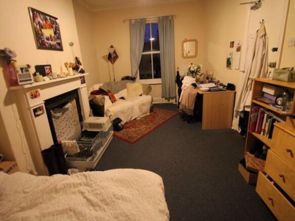 A cozy and inviting master bedroom featuring a ...