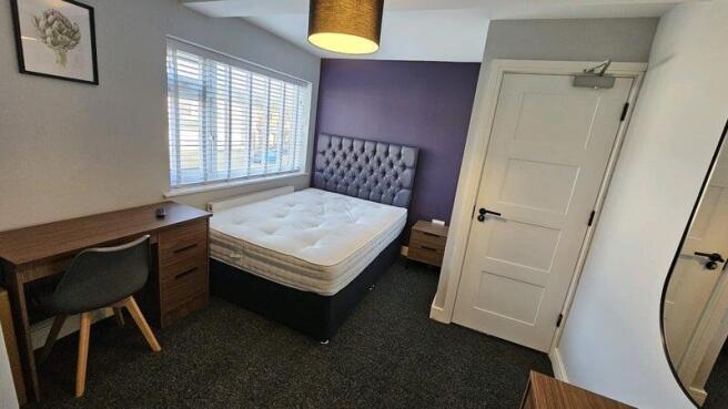 Bright, modern bedroom with a comfortable doubl...