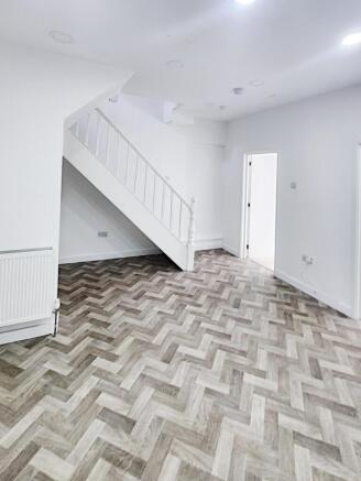 Bright, newly refurbished living area with mode...