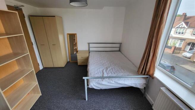 Bright and tidy double bedroom featuring a larg...