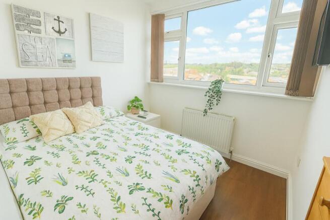 Bright and inviting double bedroom featuring a ...