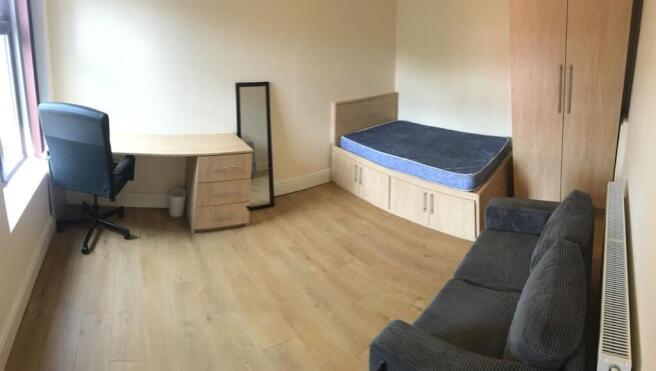 Spacious room with desk, sofa, and double bed...