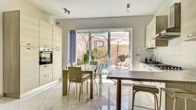 Modern kitchen with light cabinetry, a dining tabl
