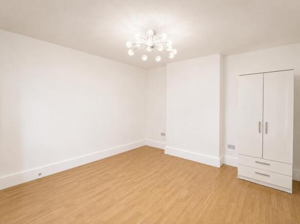 Bright bedroom with stylish lighting and wardro...