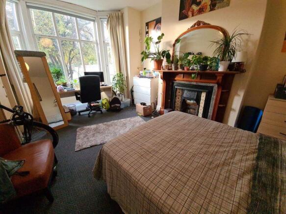 A bright and welcoming living room with large w...