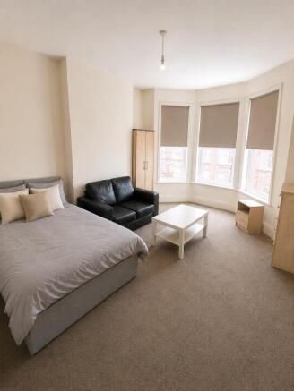 Bright master bedroom with large bay window...