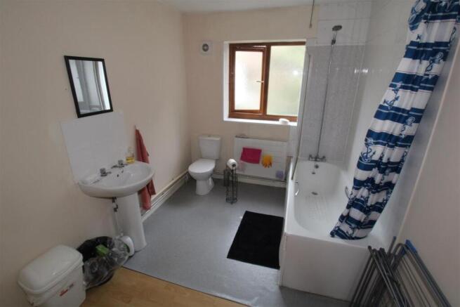 Bright and spacious bathroom with full bathtub...