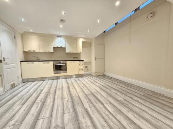 Open-plan living area and fitted kitchen