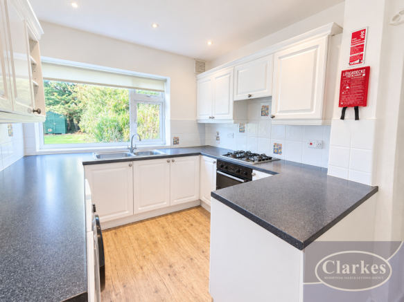 Bright, Tidy White Kitchen with Garden View