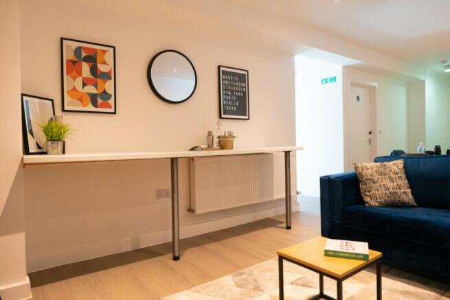 This inviting living room features a cozy blue ...