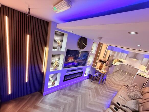 Stylish open-plan living area with built-in med...