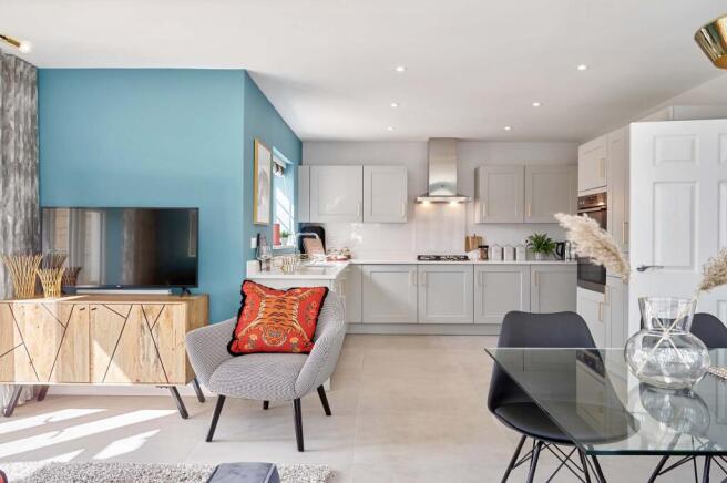 A modern living room and kitchen area features a patterned armchair and television in the foreground