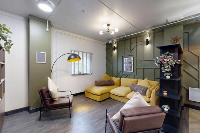 Contemporary living room with a large mustard-y...