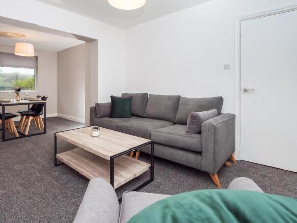 Bright, modern living room with a comfortable g...