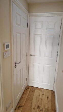 Bright hallway with stylish wood flooring...