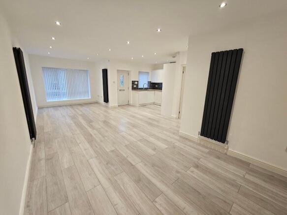 Bright open-plan living with modern wood floori...