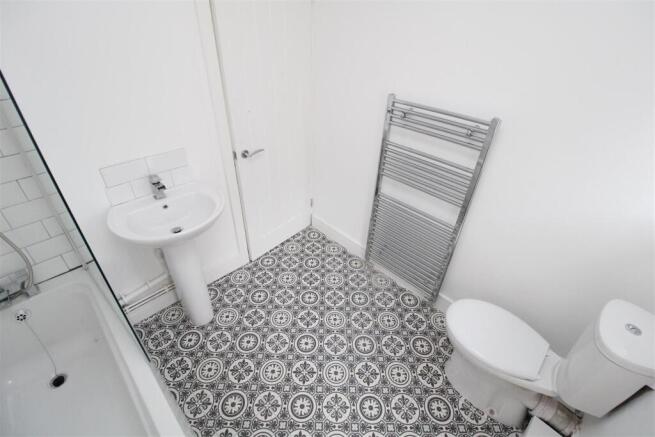 Modern bathroom with stylish patterned flooring...