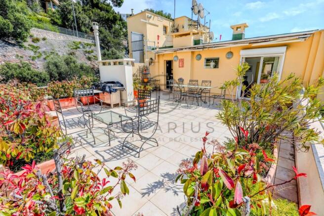 Spacious outdoor terrace with seating area and lus