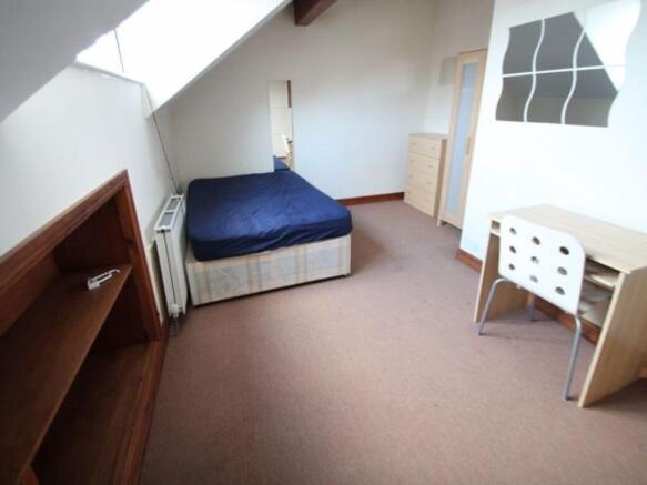 Bright and spacious bedroom featuring a comfort...