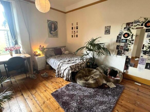 A cozy master bedroom featuring a double bed, a...