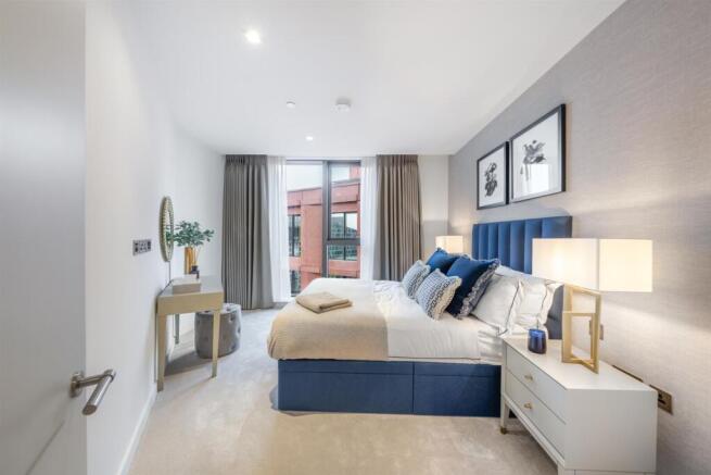 Spacious double bedroom with built-in storage in W