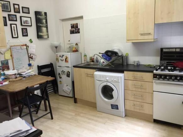 Functional kitchen with dining area with applia...