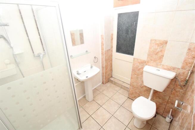 Bright bathroom with walk-in shower and tiling...