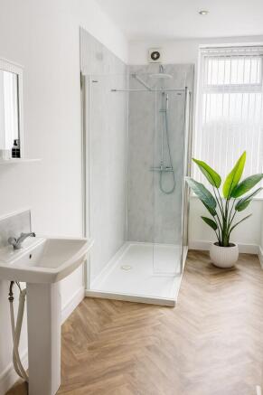Bright, modern bathroom with a walk-in glass sh...
