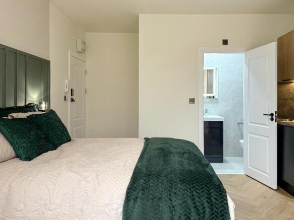 Well-presented bedroom with a neatly made doubl...