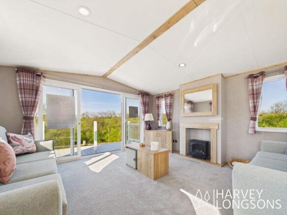 Bright living room with sofas and patio doors in A