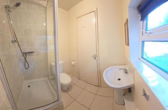 Bright, modern bathroom with a tiled shower enc...
