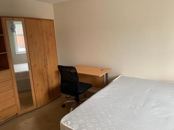 A spacious and well-equipped double bedroom fea...