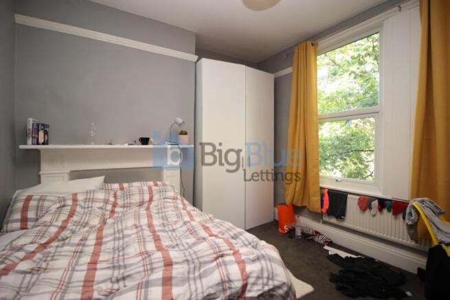 Bright and cozy double bedroom featuring a larg...