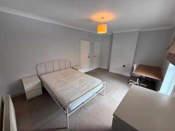 Bright, neutral double bedroom with a metal-fra...