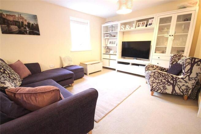 A bright and inviting living room featuring com...
