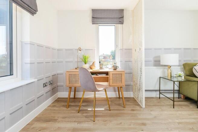 The living room offers a dedicated working from home space