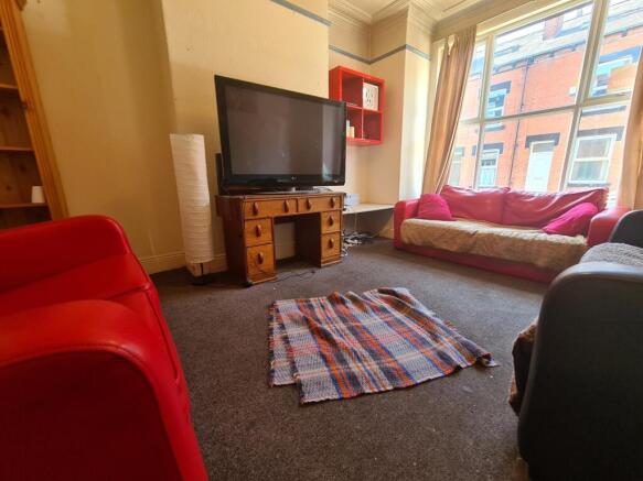 A bright, welcoming living room featuring large...