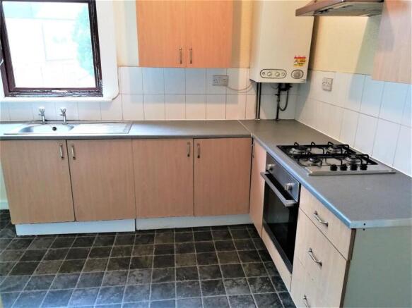 Bright kitchen with laminate countertops, gas h...