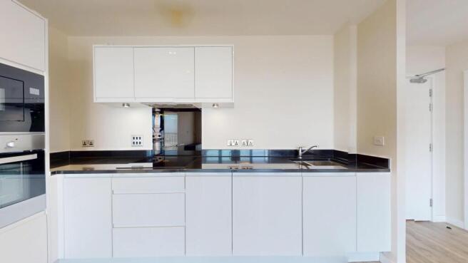 Sleek contemporary kitchen with integrated oven...