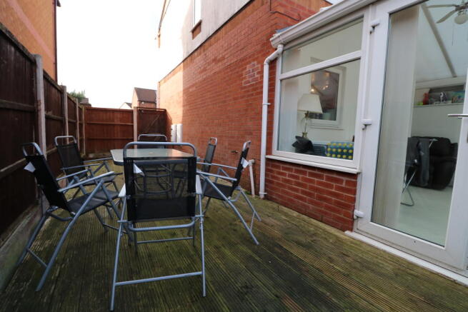 DECKED AREA TO THE SIDE OF THE PROPERTY