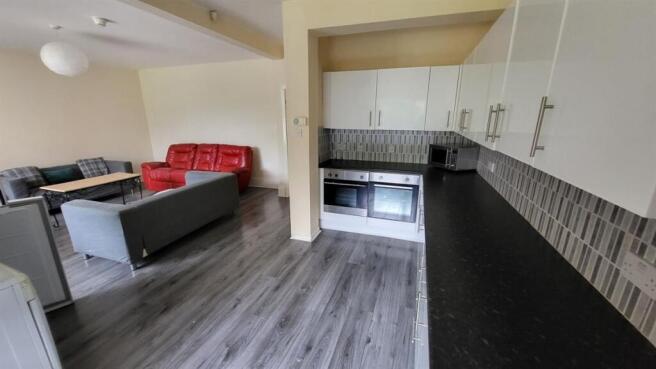 Open-plan living area with a modern kitchenette...