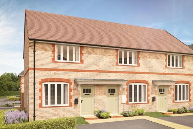 Two light brick townhouses with light green doors and white-framed windows stand in the foreground
