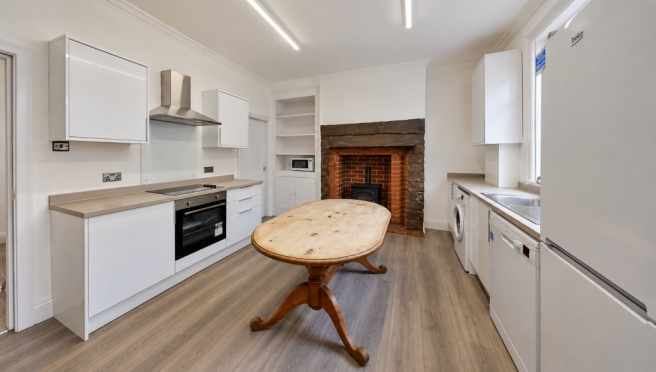 Bright Minimalist Kitchen with Oval Wood Table