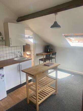 Bright kitchenette in a loft conversion with a ...